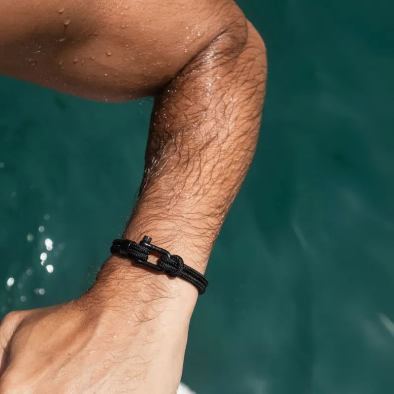 Black rope bracelet worn on a wrist, showcasing its modern style